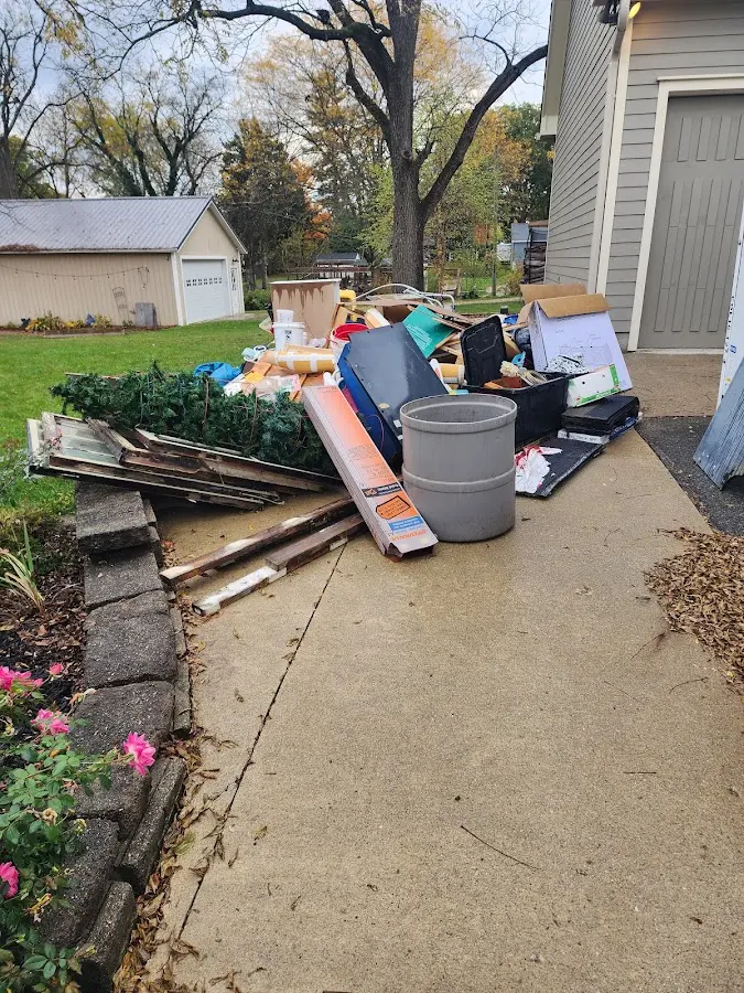 Dumpster being loaded with debris for 10 Yard Dumpster Rental in Creve Coeur